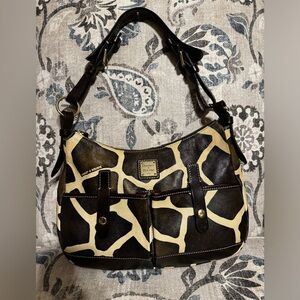 Dooney and Bourke shoulder bag in a giraffe print style.